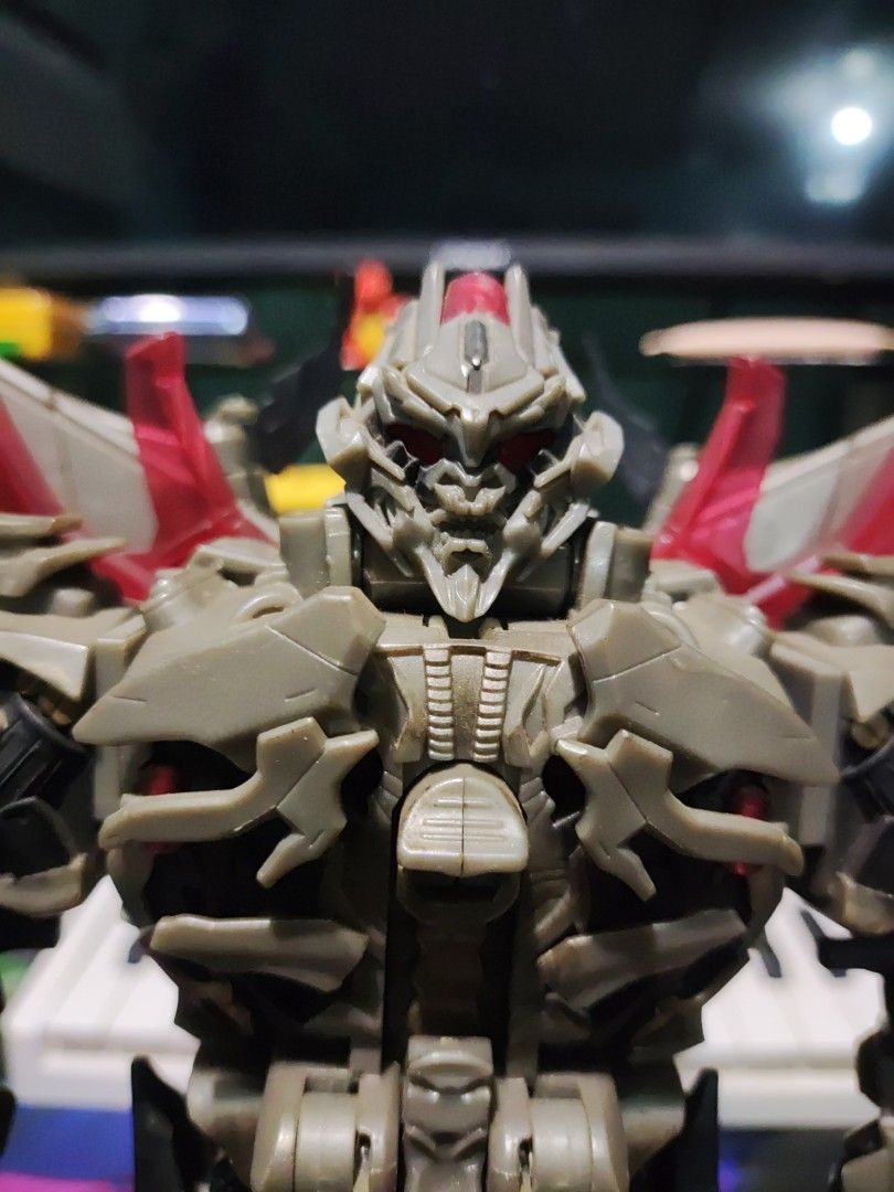 Transformers Movie Leader Class Megatron Action Figure (Category: Figurines & Statues) located in Manila. Submitted by miguelinvictus (Listing ID 1466138022, Image 2). Description: - Character: Megatron (Transformers) - Design: Detailed robot sculpt with grey and tan parts, plus red translucent accents - Articulation: Jointed limbs and torso for & dynamic posing; stands upright on its own - Mode: Fully transforms into vehicle mode - Condition: Ca