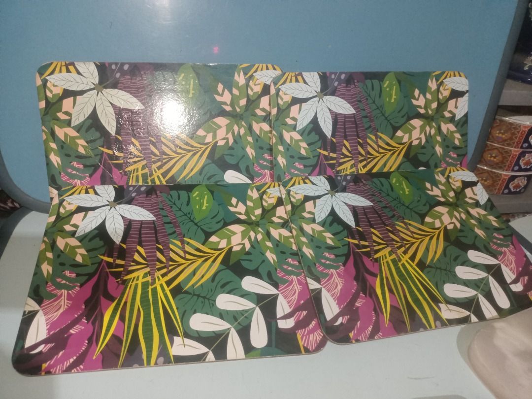 Tropical Leaf Pattern Placemats Set 3 pieces (Category: Dinnerware & Cutlery) located in Munoz. Submitted by larryc1212 (Listing ID 1466131080, Image 1). Description: - Set of rectangular placemats with a vibrant tropical leaf print - Colorful botanical design in greens, pinks, yellows, and white on a dark background - Hard-wearing surface with safe, rounded corners - Perfect for adding a fresh, lively vibe to your dining table - Clean condition 
