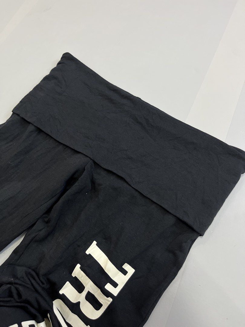 True Religion Foldover Flared Pants Black Medium (Category: Jeans) located in Mabalacat. Submitted by aas_thriftfings (Listing ID 1465992202, Image 3). Description: - Brand: True Religion - Style: Black flared pants with foldover waistband - Detail: White vertical text graphic on left leg - Size: Medium (Waist: 30-32 inches, Length: 37 inches) - Material: Soft, stretchy cotton, modal, and spandex blend - Condition: Excellent.