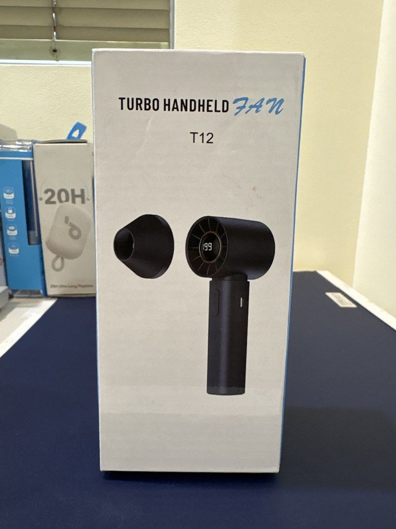 Turbo Handheld Fan T12 Digital Display (Category: Fans) located in Manila. Submitted by dobronxsglazer (Listing ID 1466048910, Image 3). Description: Turbo handheld fan model T12 in black. 100 speed control settings with a digital display showing battery percentage. Concentrated turbo wind with low noise operation. Output power up to 10W, DC 5V rated voltage, 3.7V battery. Compact size, easy to carry around in a bag. Original box included. - Cone