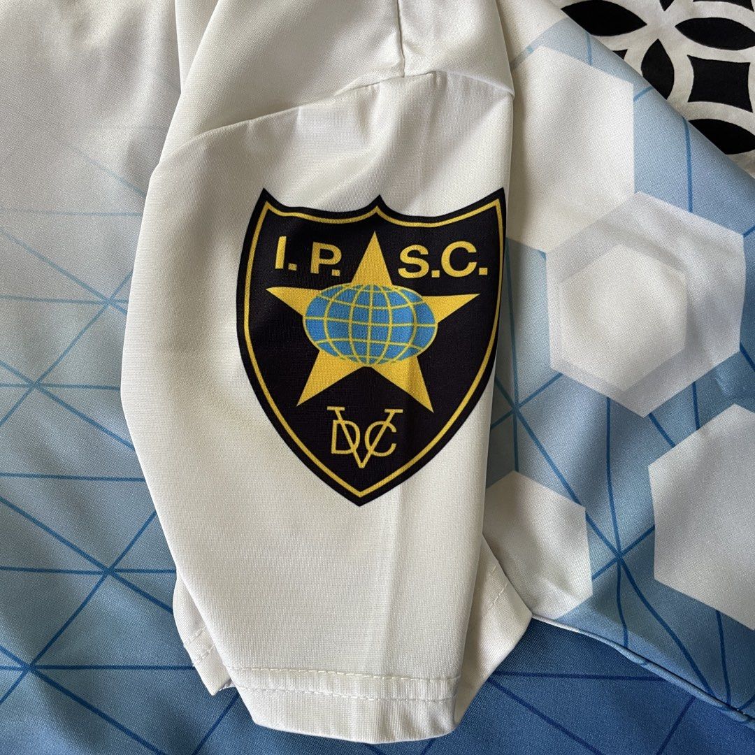 Turcoman CZ IPSC Polo Shirt Size M (Category: Tshirts & Polo Shirts ) located in Manila. Submitted by xeych (Listing ID 1465977519, Image 3). Description: - Brand: Turcoman - Color/Design: White and blue gradient with geo-grid and hexagonal patterns - Size: M (tagged on collar) - Branding: CZ and IPSC prints on front, back, and sleeve - Material: Smooth athletic fabric - Style: Button-up collar.
