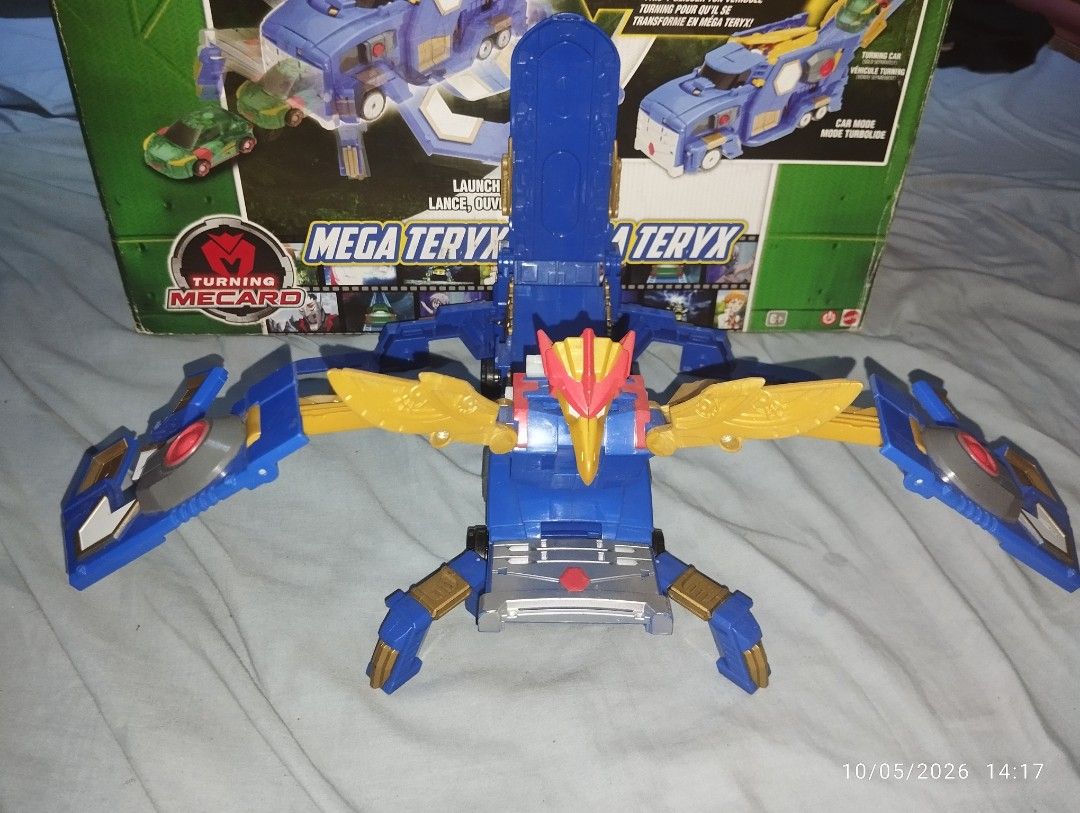 Turning Mecard Mega Teryx Transforming Robot Toy with Box (Category: Action & Battle Toys) located in Manila. Submitted by watertubig_091123 (Listing ID 1466016949, Image 2). Description: - Official Turning Mecard Mega Teryx toy complete with the original box - Smooth 2-in-1 transformation from a blue truck to a robotic creature - Features automatic wing-flip and head-pop action during conversion - Durable blue, gold, and red plastic construction