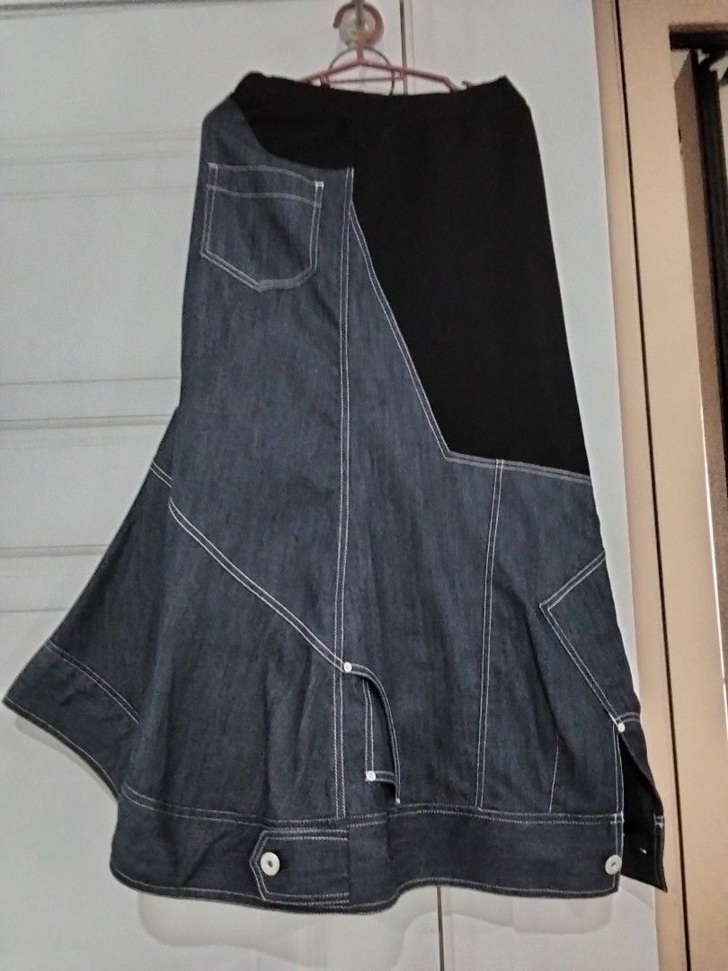 UN3D. Contrast Panel Denim Midi Skirt (Category: Skirts) located in Manila. Submitted by jeansuaco942346 (Listing ID 1465965888, Image 2). Description: - Brand: UN3D. (MARK STYLER) - Design: Denim and black fabric panel skirt with asymmetric buttoned hem - Details: Contrast white stitching, back pocket, and comfortable elastic waistband - Material: Cotton, polyester, and polyurethane blend - Origin: Made in China.