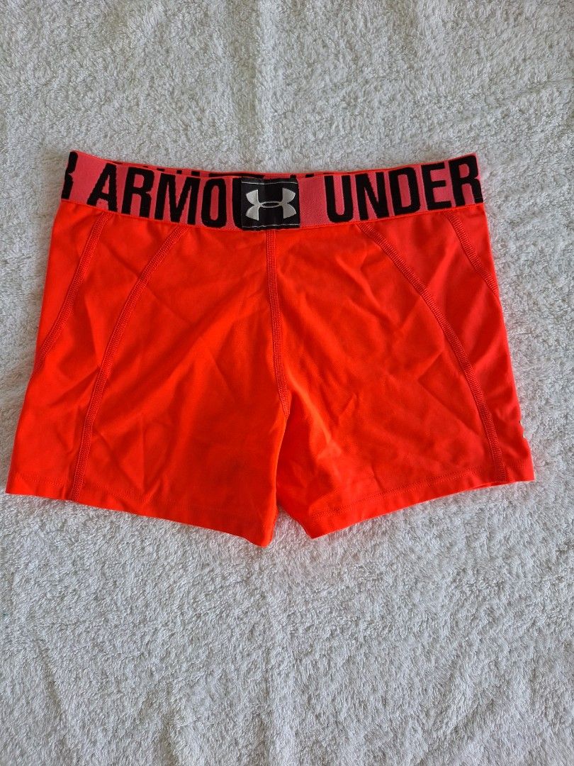 UNDER ARMOUR CYCLING / ATHLETIC COMPRESSION - NEON ORANGE (Category: Activewear) located in Abucay. Submitted by petiteprettyboutiquev2 (Listing ID 1465970364, Image 1). Description: 🍃Bright orange Under Armour athletic compression or spandex shorts with a wide black branded waistband. + SF (J&T).