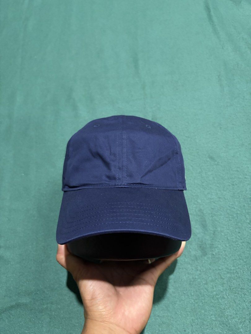 Under Armour Navy Blue Baseball Cap Hat (Category: Caps & Hats) located in Guihulngan. Submitted by fbthriftgoodsniace (Listing ID 1466014163, Image 2). Description: - Brand: Under Armour - Color: Classic Navy Blue - Design: 6-panel structure with embroidered white logo on the side - Brim: Clean, curved design - Closure: Adjustable strapback with silver metal hardware - Condition: Brand new / Excellent - Best for: Gym workouts, sports, or everyda