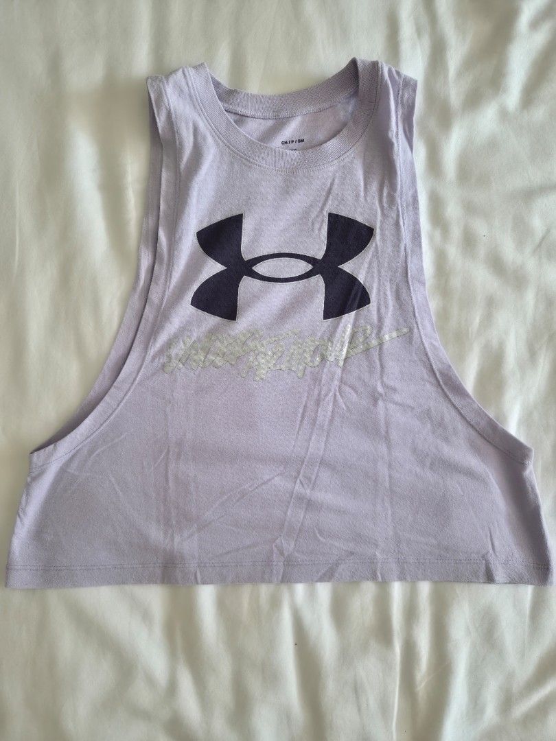 Under Armour Purple Tank Top Size S (Category: Sleeveless) located in Quezon City. Submitted by corrnic (Listing ID 1465996315, Image 2). Description: - Brand: Under Armour - Color: Light purple - Size: Small - Design: Large front logo graphic with textured lettering detail - Cut: Scoop neckline, sleeveless - Fabric: Lightweight and breathable - Ideal for: Gym workouts, running, and training sessions.