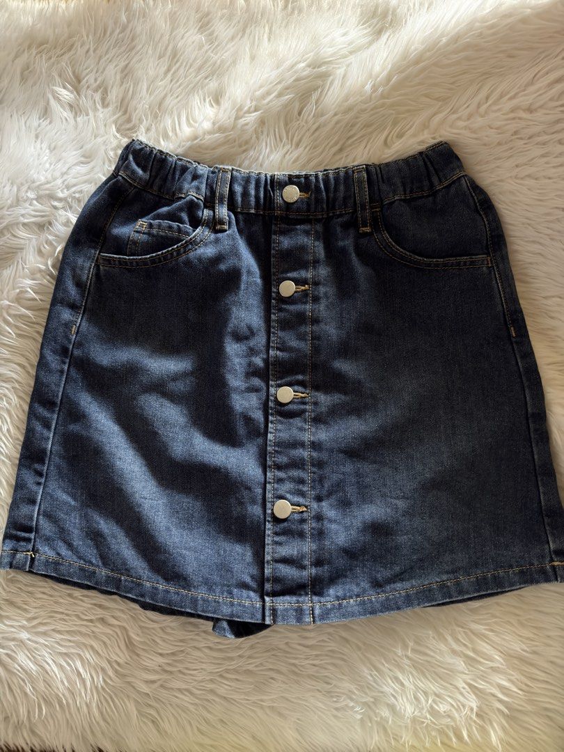 Uniqlo Denim Skort Size S (Category: Skirts) located in Davao. Submitted by keirousel (Listing ID 1466034206, Image 1). Description: - Brand: Uniqlo - Item: Denim skirt with built-in shorts - Color/Wash: Dark blue - Size: 150 (tag inside) - Waistband: Elastic at the back - Closure: Front button closure down the middle - Pockets: Functional pockets on the front.