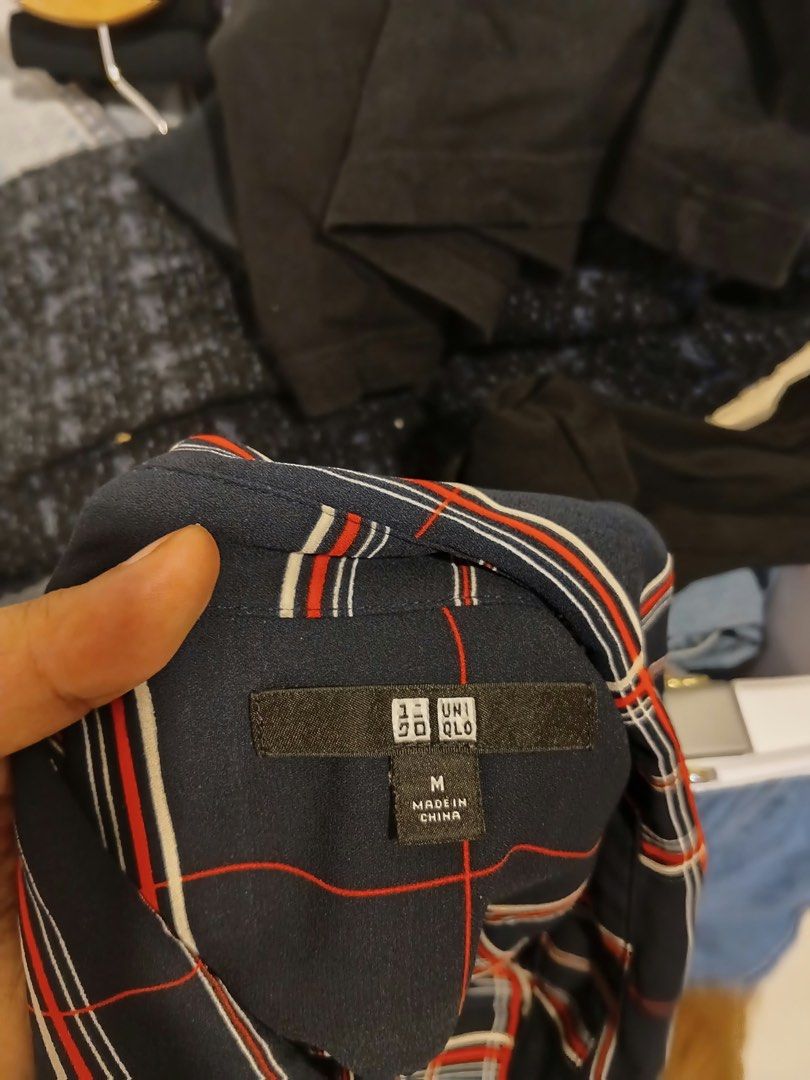 Uniqlo Navy Blue Plaid Button Down Blouse Size M (Category: Blouses) located in Antipolo. Submitted by wisecat.4a7eea (Listing ID 1466043493, Image 3). Description: - Brand: Uniqlo - Item: Plaid Long Sleeve Button-Down Blouse - Color: Navy blue base with red and white plaid pattern - Size: Medium (Bust: 80-86cm, Height: 160/84A) - Material: 100% Polyester - Details: Collared neckline, button front, button cuffs, high-low curved hemline - Conditio