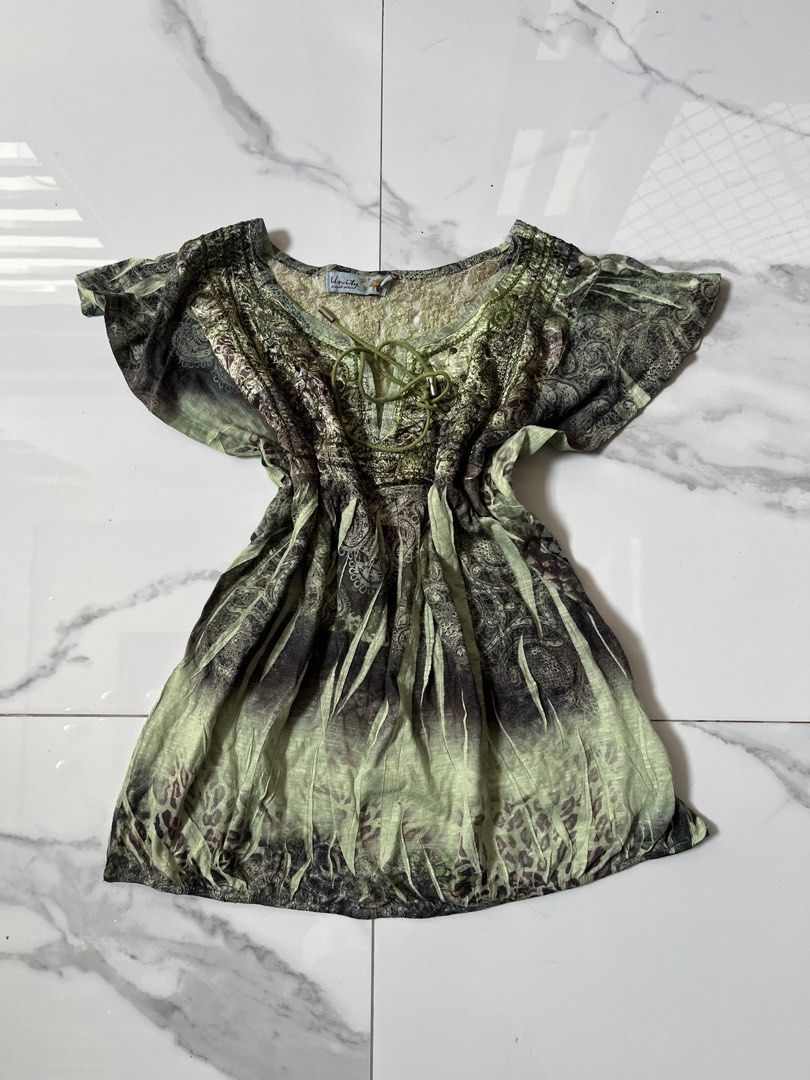Unity World Wear Green Boho Print Blouse Top (Category: Blouses) located in Caloocan City. Submitted by crucifiedtearz (Listing ID 1466010324, Image 1). Description: - Brand: Unity World Wear - Style: Boho green and black blouse - Details: Intricate paisley & animal prints, tie neckline, and chest stud detailing - Fit: Short flutter sleeves and cinched waist design - Fabric: Lightweight, ideal for casual wear and summer outings.