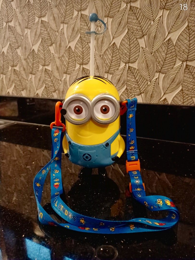 Universal Studios Minion Popcorn Bucket Drink Sipper (Category: Character Goods) located in Binan City. Submitted by thrifty.08 (Listing ID 1466078819, Image 1). Description: - Authentic Universal Studios Minions popcorn bucket and drink sipper - Iconic design featuring a yellow body, blue overalls, and big double goggles - Includes a clear straw with a secure blue cap piece - Comes with an adjustable long blue lanyard printed with Universal Stud