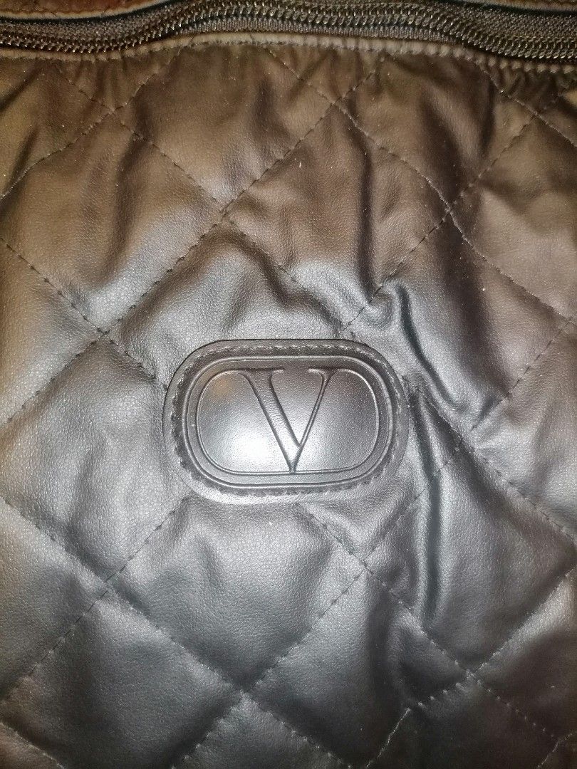 Valentino garavani Black Duffle bag (Category: Luxury Bags & Wallets) located in Digos. Submitted by crodualady82694 (Listing ID 1466047654, Image 1). Description: - Stylish black quilted travel bag with Valentino logo patch and side branding - Spacious zippered main compartment ideal for weekend getaways or the gym - Sturdy top handles and a convenient adjustable shoulder strap for easy carrying - Durable fabric construction that holds its shape