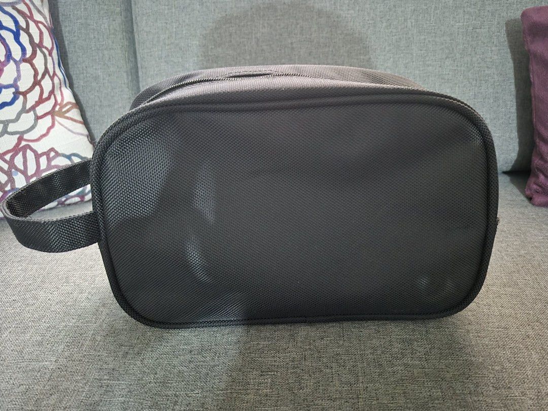 Van Heusen Toiletry Bag Travel Pouch (Category: Purses & Pouches) located in Manila. Submitted by munggomooo (Listing ID 1466023735, Image 2). Description: - Brand: Van Heusen - Color/Material: Dark grey textured fabric - Compartments: Spacious main zip compartment with smooth black lining and front zippered pocket - Portability: Convenient side grab handle for carrying or hanging - Condition: Clean interior and exterior with smooth, working zipp