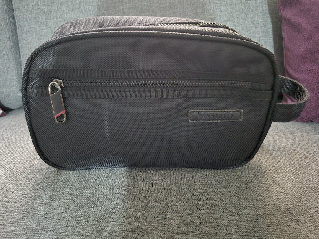 Van Heusen Toiletry Bag Travel Pouch (Category: Purses & Pouches) located in Manila. Submitted by munggomooo (Listing ID 1466023735, Image 1). Description: - Brand: Van Heusen - Color/Material: Dark grey textured fabric - Compartments: Spacious main zip compartment with smooth black lining and front zippered pocket - Portability: Convenient side grab handle for carrying or hanging - Condition: Clean interior and exterior with smooth, working zipp