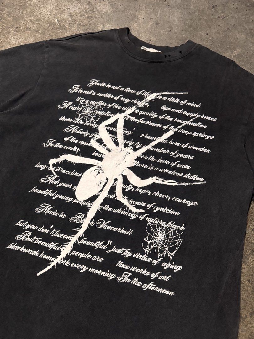 Vancarhell Spider Graphic Distressed T-shirt (Category: Tshirts & Polo Shirts ) located in Pasig City. Submitted by dripthrift1600 (Listing ID 1466098525, Image 3). Description: - Brand: Vancarhell - Size: L - Color: Black with heavy pigment wash - Material: 100% thick, sturdy cotton - Design: Large white spider graphic with typewriter-style text and spiderweb details - Details: Distressed holes on the collar ribbing for a vintage, worn-in aesthe
