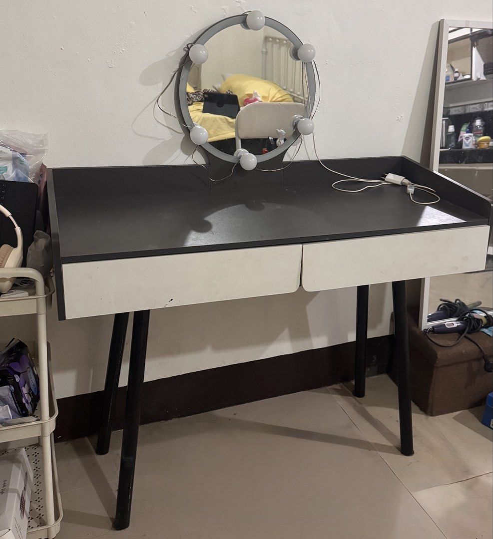 Vanity table with lighted round mirror and drawers (Category: Tables & Sets) located in Manila. Submitted by flyingyvon (Listing ID 1466121124, Image 2). Description: - Modern vanity table with a round lighted mirror - Dark grey tabletop with ample space for makeup and skincare - Two convenient white storage drawers underneath - Sturdy black angled legs for support - Includes power cord with a handy switch - Pickup preferred due to size.