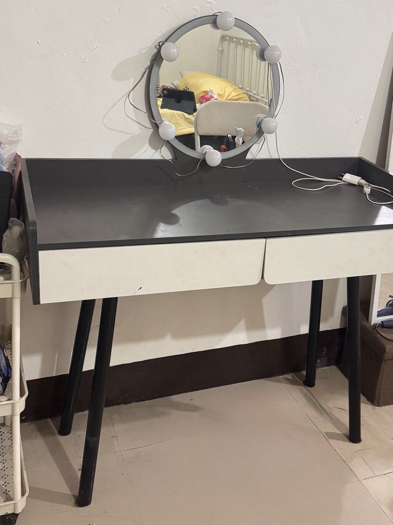 Vanity table with lighted round mirror and drawers (Category: Tables & Sets) located in Manila. Submitted by flyingyvon (Listing ID 1466121124, Image 1). Description: - Modern vanity table with a round lighted mirror - Dark grey tabletop with ample space for makeup and skincare - Two convenient white storage drawers underneath - Sturdy black angled legs for support - Includes power cord with a handy switch - Pickup preferred due to size.