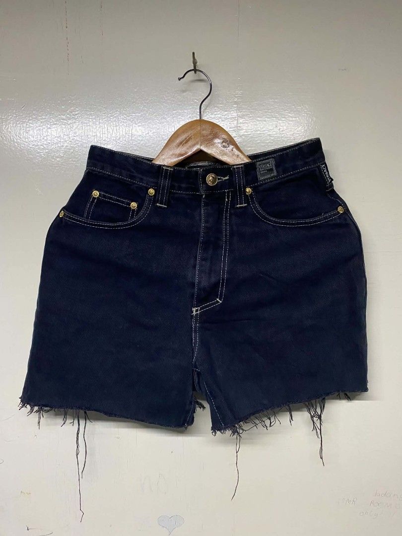 Versace Jeans Couture Dark Denim Shorts (Category: Shorts) located in Pasig City. Submitted by jstnisidor81288 (Listing ID 1466103188, Image 1). Description: - Brand: Versace Jeans Couture - Color: Dark blue denim with contrast white stitching - Fit: High-waisted with gold-tone logo hardware - Details: Signature leather logo patch on rear waistband, front and rear pockets - Hem: Distressed raw hem with frayed fringe threads - Style: Heavy vintage