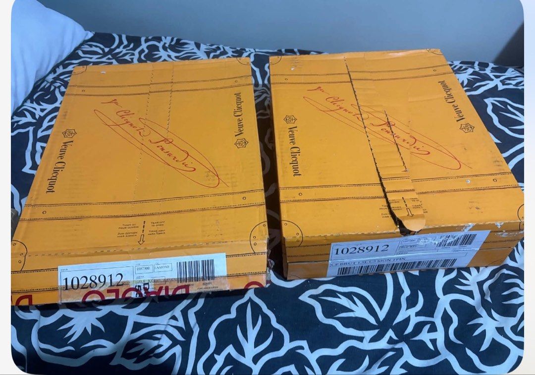 Veuve Clicquot Champagne Boxes 1.5L (Category: Beverages) located in Cainta. Submitted by pie721 (Listing ID 1466008219, Image 1). Description: - Set of 2 Veuve Clicquot cardboard boxes designed like little vintage trunks - Iconic bright yellow color with signature branding - Features authentic barcodes and product codes on the front edges - 3 bottles of 1.5L per box - Perfect for special events - Selling as a set or per bottle.