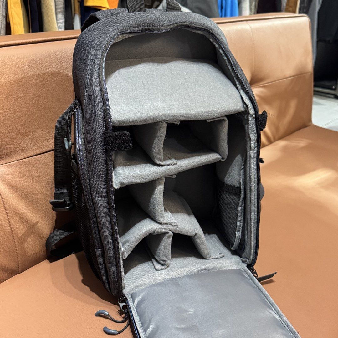 Victory Grey Camera Backpack with Adjustable Dividers (Category: Camera Bags & Carriers) located in Rizal. Submitted by houseofbell (Listing ID 1466150370, Image 3). Description: - Brand: Victory - Color: Grey and dark grey with a small compass logo patch - Storage: Fully opening main compartment with customizable padded velcro dividers - Pockets: Multiple exterior zippered pockets and mesh side pockets - Comfort: Breathable padded single-strap s