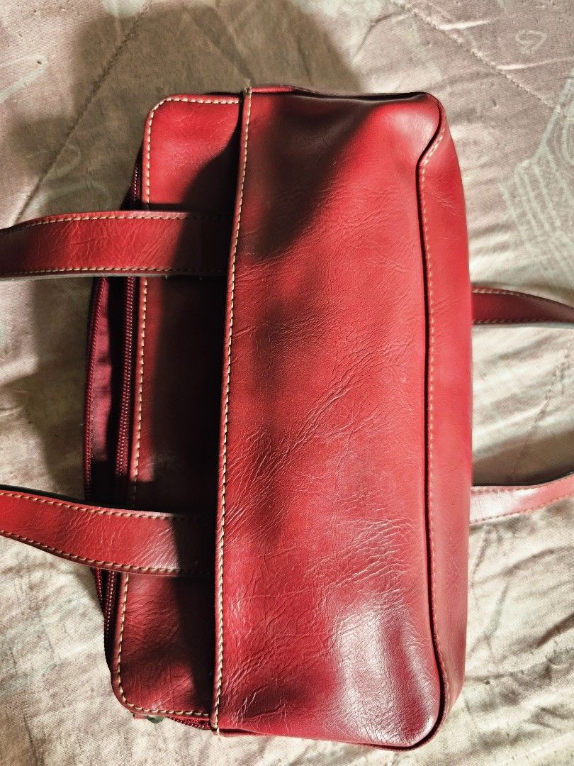 Villager Red Leather Shoulder Bag with Multiple Compartments (Category: Shoulder Bags) located in Quezon City. Submitted by jackielicious17 (Listing ID 1466011088, Image 2). Description: - Brand: Villager - Color: Rich red with matching deep red fabric lining - Storage: Multiple interior and exterior zippered compartments - Exterior: Front slip pocket featuring a stylish metal logo plate - Straps: Sturdy double shoulder straps for comfortable dai