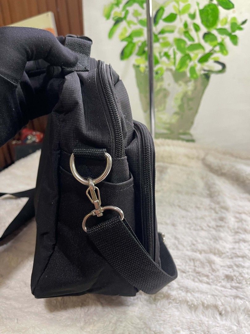 Villand Black sling Bag (Category: Cross-body Bags) located in Naawan. Submitted by twilly.apparel2 (Listing ID 1465978578, Image 2). Description: - issue sa loob Brand: Villand - Color: Solid black canvas with silver hardware - Storage: Multiple front zipped compartments for small items - Carrying Options: Sturdy top handle and long adjustable strap - Best For: Daily commutes, work, and everyday use.