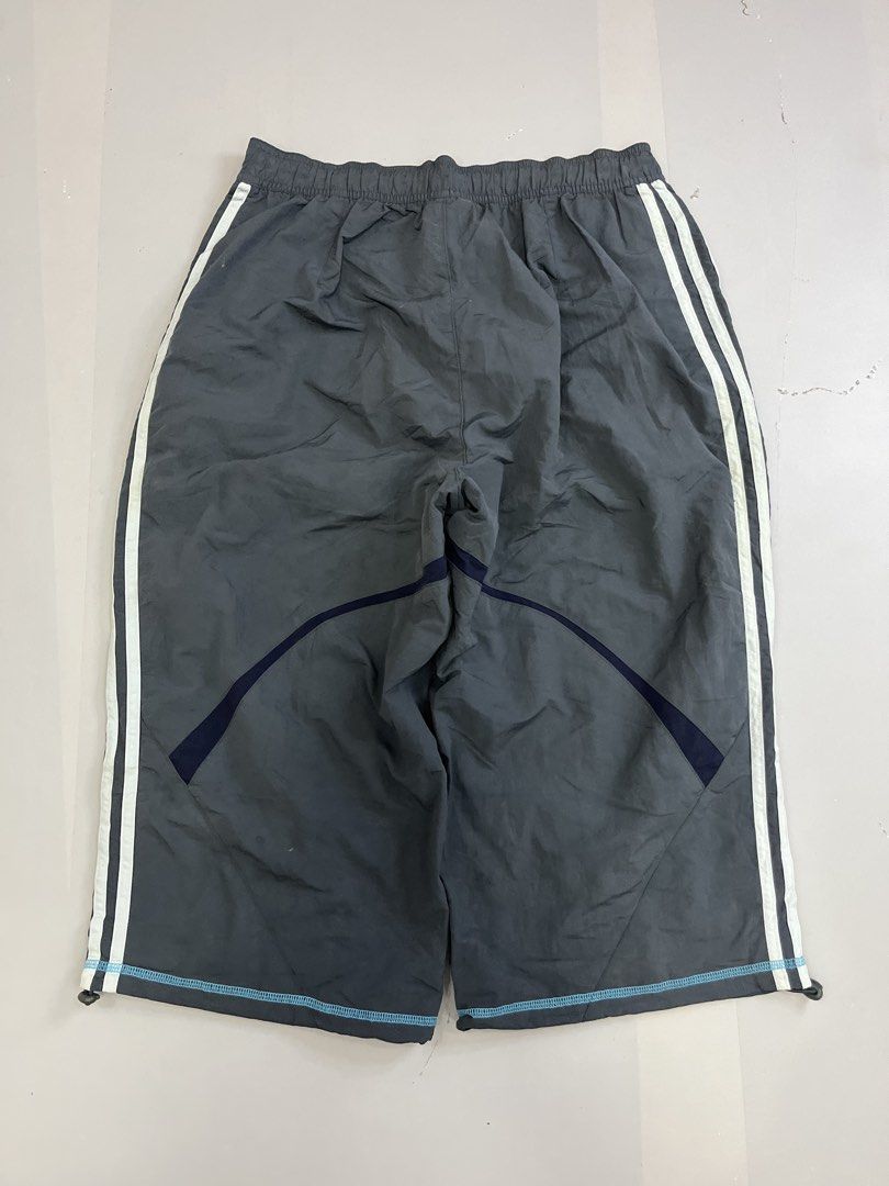 Vintage Adidas Grey Capri (Category: Joggers) located in Mabalacat. Submitted by aas_thriftfings (Listing ID 1465991326, Image 2). Description: - Brand: Adidas - Style: Windbreaker Track Pants - Color: Grey with white side stripes and light blue logo - Size: L (175/82A measurements) - Features: Elastic waistband with adjustable drawstring, comfortable inner mesh lining - Origin: Made in China.