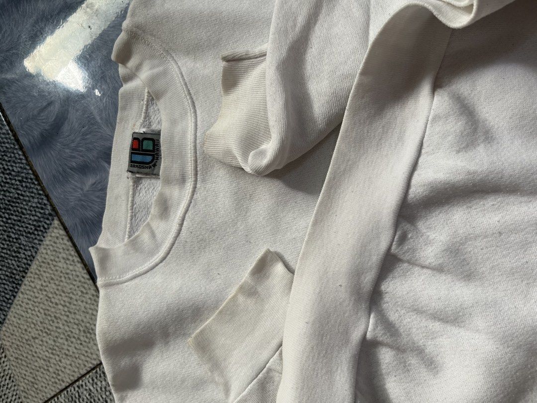 Vintage Bradshaw Hawaii Surf (Category: Coats, Jackets and Outerwear) located in Quezon City. Submitted by thriftshop_treasure (Listing ID 1466106055, Image 2). Description: vintage white crewneck sweatshirt featuring a surfboard and floral lei graphic on the back with “Bradshaw Hawaii Surf” 25x28.