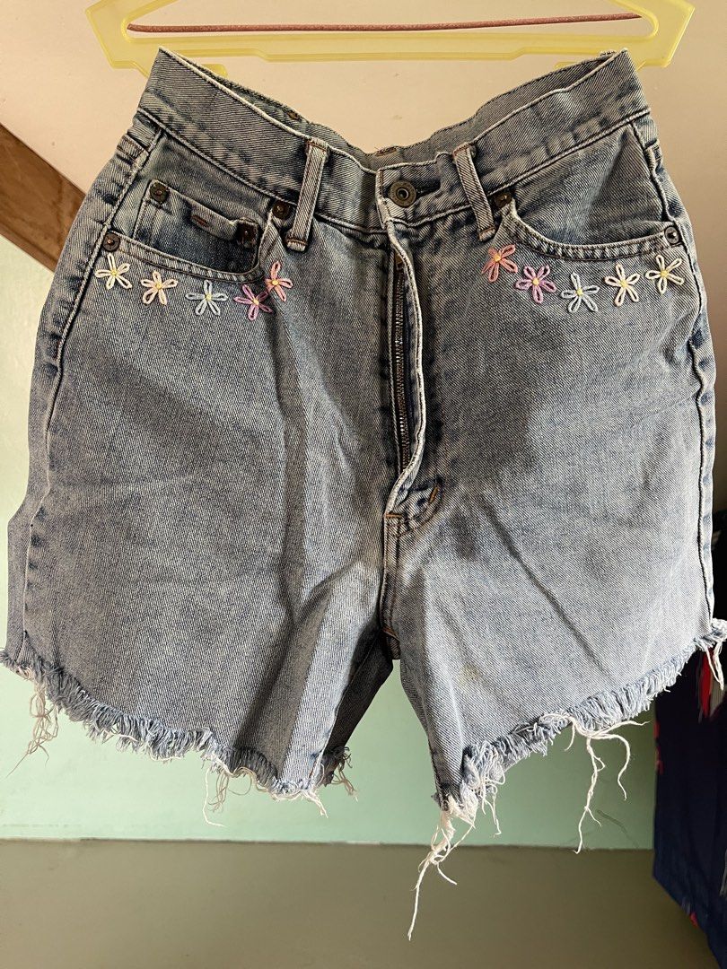 Vintage Denim Shorts (Category: Shorts) located in Baybay. Submitted by shikita27906 (Listing ID 1466028912, Image 1). Description: - Light wash denim shorts with high-waisted fit - Adorable handmade colorful flower embroidery on both front pockets - Trendy raw frayed hem detail - Secure zipper fly with button closure - Waist measures approx. 13 inches across laid flat.
