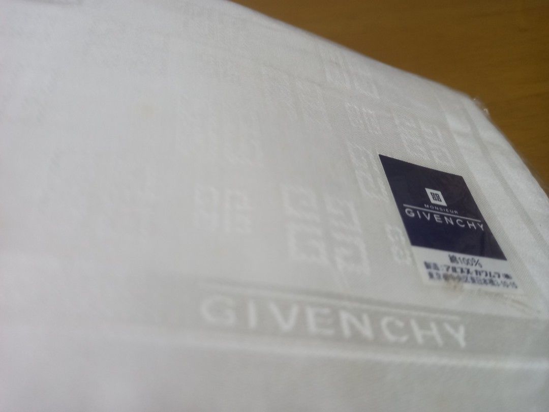 Vintage Givenchy Handkerchief 100% Cotton (Category: Handkerchief & Pocket Squares) located in Manila. Submitted by riaring88 (Listing ID 1466087412, Image 2). Description: - Brand: Givenchy - Color: Classic White - Material: 100% Premium Cotton - Design: Jacquard-woven 4G monogram pattern with printed Givenchy brand name near the border - Condition: Brand new, sealed in original plastic packaging with official brand label sticker - Ideal for per