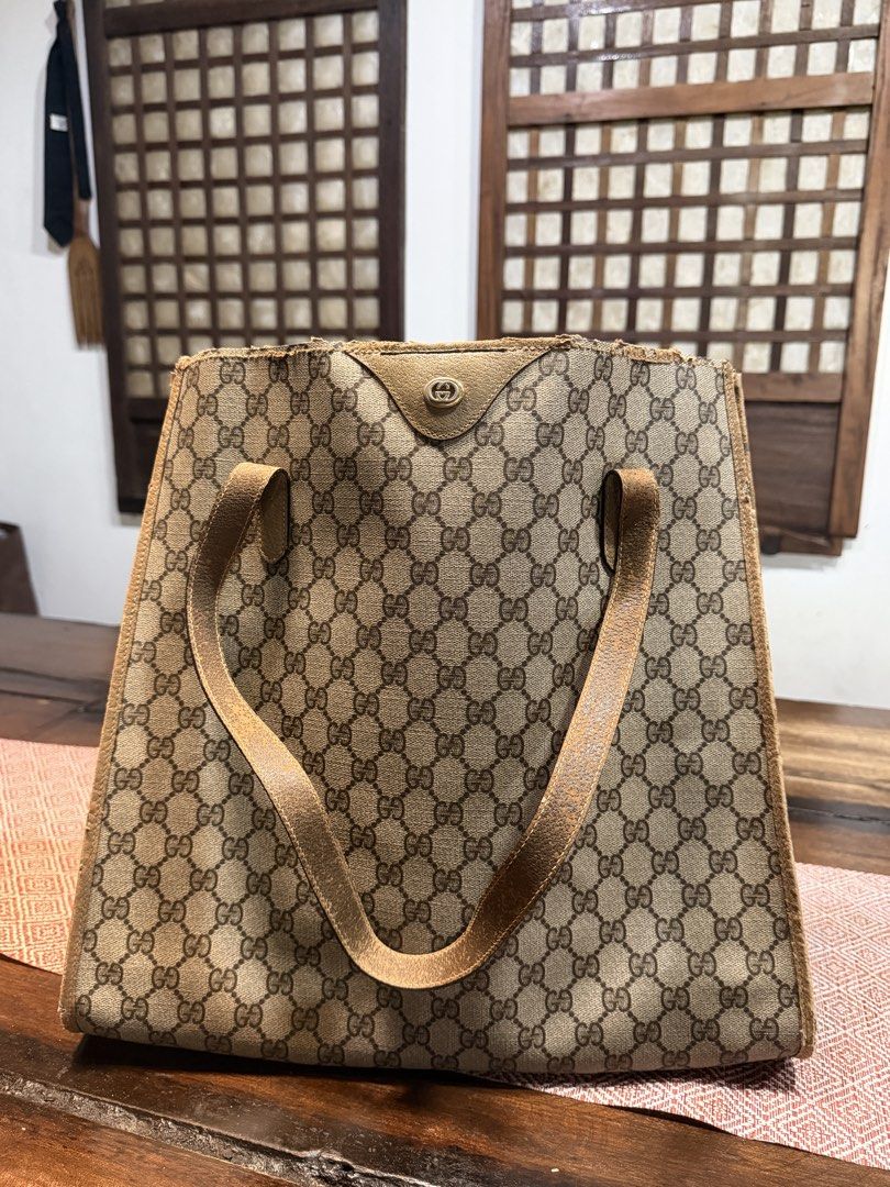 Vintage Gucci Monogram Canvas Tote Bag (Category: Luxury Bags & Wallets) located in Las Pinas. Submitted by 4fc4da554628523b1a7a6f2572133d (Listing ID 1466103326, Image 1). Description: - Authentic Gucci GG monogram coated canvas tote - Features dual leather shoulder straps and gold-tone hardware - Condition: Heavy wear on handles (peeling/cracking) and top trim (fraying/scuffs) - Great project piece for restoration or as a vintage daily runner -