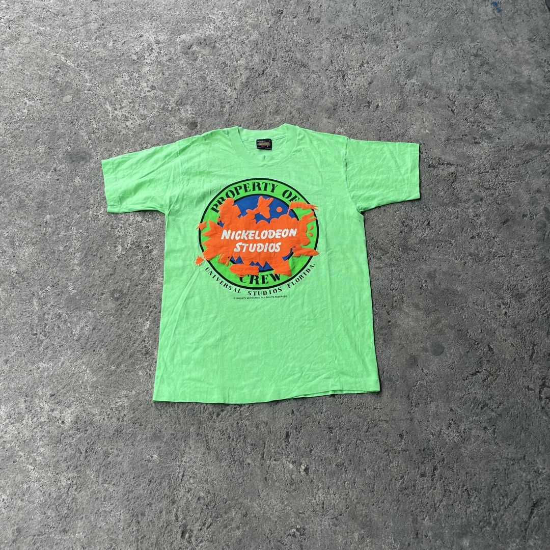 Vintage Nickelodeon Studios Universal Studios Florida Crew T-Shirt (Category: Tshirts & Polo Shirts ) located in Polangui. Submitted by b0ssl00ts (Listing ID 1465961829, Image 1). Description: - Authentic 1990 vintage Nickelodeon Studios Universal Studios Florida crew tee - Color: Bright green with a large, bold chest graphic - Size: Medium (Universal Studios collar tag) - Material: Soft, comfortable cotton feel - Condition: Rare piece of 90s TV 