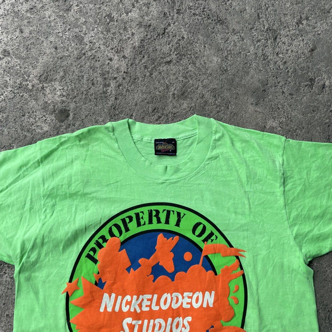 Vintage Nickelodeon Studios Universal Studios Florida Crew T-Shirt (Category: Tshirts & Polo Shirts ) located in Polangui. Submitted by b0ssl00ts (Listing ID 1465961829, Image 2). Description: - Authentic 1990 vintage Nickelodeon Studios Universal Studios Florida crew tee - Color: Bright green with a large, bold chest graphic - Size: Medium (Universal Studios collar tag) - Material: Soft, comfortable cotton feel - Condition: Rare piece of 90s TV 