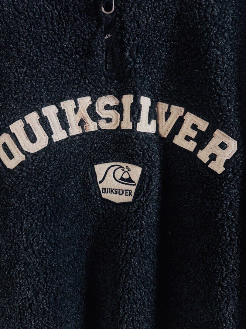 Vintage Quiksilver (Category: Coats, Jackets and Outerwear) located in Roxas City. Submitted by patsquarephantz (Listing ID 1466091021, Image 3). Description: - Brand: Quiksilver - Style: Dark grey fuzzy fleece pullover with quarter zip and high collar - Size: L - Details: Large embroidered chest logo with wave patch below - Material: Thick, warm sherpa fabric - Fit: Regular fit, perfect for chilly weather.