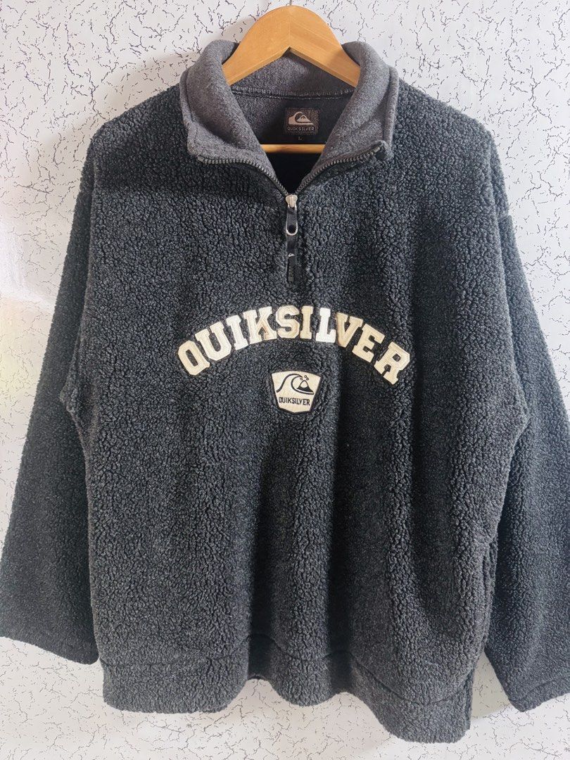 Vintage Quiksilver (Category: Coats, Jackets and Outerwear) located in Roxas City. Submitted by patsquarephantz (Listing ID 1466091021, Image 1). Description: - Brand: Quiksilver - Style: Dark grey fuzzy fleece pullover with quarter zip and high collar - Size: L - Details: Large embroidered chest logo with wave patch below - Material: Thick, warm sherpa fabric - Fit: Regular fit, perfect for chilly weather.