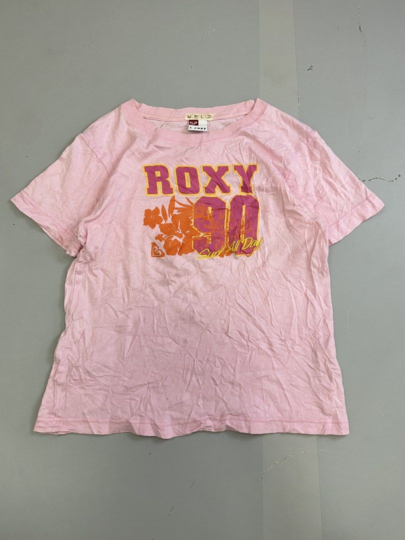 Vintage Roxy Pink Graphic T-Shirt (Category: Shirts) located in Mabalacat. Submitted by aas_thriftfings (Listing ID 1465993398, Image 1). Description: - Brand: Roxy - Color: Pink - Size: Small - Material: 100% Cotton - Design: Large floral 'Roxy 90 Surf All Day' front graphic - Details: Small 'R' logo on lower back hem, short sleeves, ribbed crew neckline - Condition: Excellent, buyer-friendly deal!.