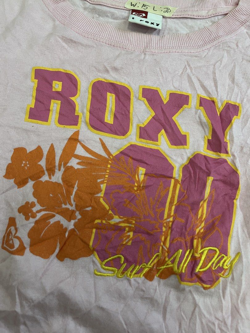 Vintage Roxy Pink Graphic T-Shirt (Category: Shirts) located in Mabalacat. Submitted by aas_thriftfings (Listing ID 1465993398, Image 3). Description: - Brand: Roxy - Color: Pink - Size: Small - Material: 100% Cotton - Design: Large floral 'Roxy 90 Surf All Day' front graphic - Details: Small 'R' logo on lower back hem, short sleeves, ribbed crew neckline - Condition: Excellent, buyer-friendly deal!.