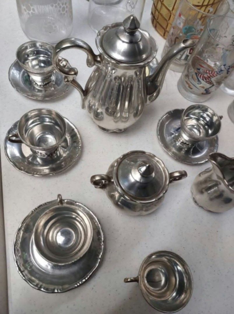 Vintage silver plated tea set with pot and cups (Category: Coffee & Tea Tableware) located in Las Pinas. Submitted by michtradingandventures (Listing ID 1465986970, Image 1). Description: - Vintage silver-plated tea set in a charming fluted panel design - Includes a tall teapot, matching sugar bowl, cream jug, and multiple cups with saucers - Beautiful polished finish with a natural patina from age and storage - Perfect for elegant afternoon tea 