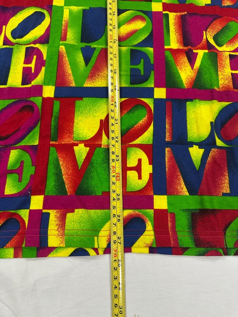 Vintage VERSACE LOVE Shirt (Category: Luxury Apparel) located in San Juan City. Submitted by looneybin559 (Listing ID 1466005312, Image 3). Description: Authentic Gianni Versace LOVE shirt. Vintage. Just in storage. Hard to find. Collector's Item. Runway Piece. Size Small. - Cool vintage t-shirt - Repeating 'LOVE' graphic with a bright, colorful all-over print - Perfect for achieving a retro or unique look - One-of-a-kind piece you won't find eve