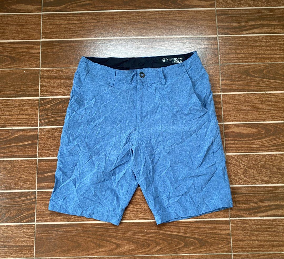 Volcom Surf N Turf 4-Way Stretch Blue Shorts (Category: Shorts) located in Cebu City. Submitted by thriftpherskzai (Listing ID 1466074480, Image 1). Description: - Brand: Volcom - Color: Blue - Material: Lightweight 4-way stretch fabric for maximum comfort - Closure: Button waist with belt loops - Pockets: Right zippered back pocket with Volcom logo patch and left buttoned back pocket - Details: Subtle Volcom stone logo rubber print near the hem 