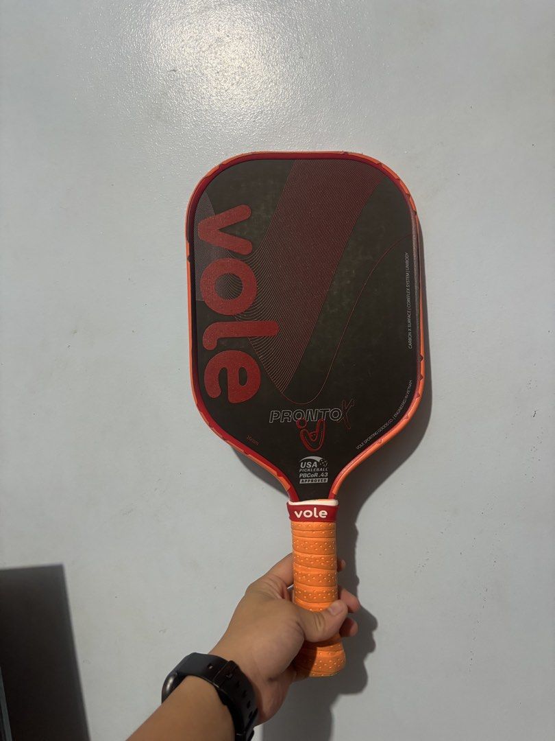 Vole Pronto X 16mm Pickleball Paddle (Category: Racket and Ball Sports) located in Mandaluyong City. Submitted by jb_toys (Listing ID 1465984149, Image 2). Description: - Model: Vole Pronto X Pickleball Paddle - Thickness: 16mm with unibody construction - Surface & Core: Carbon X surface with coreflex system - Certification: USA Pickleball PBCor.43 approved - Design: Black face, red graphics, and orange edge guard - Handle: Wrapped orange cushion