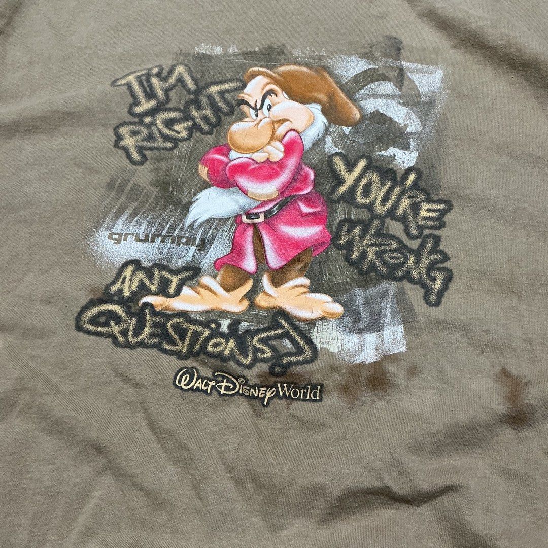 Walt Disney World Grumpy Graphic T-Shirt (Category: Tshirts & Polo Shirts ) located in Naga. Submitted by eunhasowon12391 (Listing ID 1466077840, Image 2). Description: - Authentic Disney World Grumpy graphic tee with the quote "I'm right you're wrong any questions?" - Official Disney tag attached at the inner collar - Relaxed fit with a comfortable, heavyweight cotton feel - Tan colorway - Flaws noted: Noticeable discoloration spots near the bot
