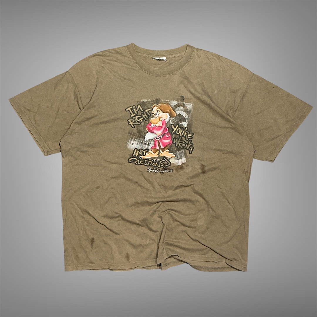 Walt Disney World Grumpy Graphic T-Shirt (Category: Tshirts & Polo Shirts ) located in Naga. Submitted by eunhasowon12391 (Listing ID 1466077840, Image 1). Description: - Authentic Disney World Grumpy graphic tee with the quote "I'm right you're wrong any questions?" - Official Disney tag attached at the inner collar - Relaxed fit with a comfortable, heavyweight cotton feel - Tan colorway - Flaws noted: Noticeable discoloration spots near the bot