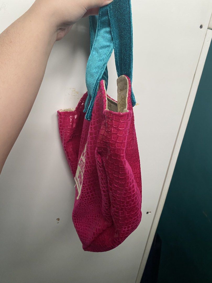 Where Sirius Dan Pink Heart Bag (Category: Shoulder Bags) located in Quezon City. Submitted by jeno_is_moving (Listing ID 1466000763, Image 2). Description: - Style: Bright pink faux snakeskin heart-shaped silhouette - Straps: Contrast teal blue velvet - Interior: Gold and white patterned fabric lining with an open pocket - Brand: Where Sirius Dan Nomadic Clothing Got it at Purveyr Fair! Used only once No flaws or any issues! Original price: P340