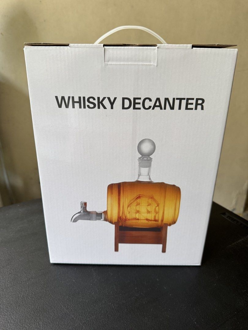 Whisky Decanter Barrel Set Model L023 (Category: Pitchers & Dispensers) located in Quezon City. Submitted by jrc_98 (Listing ID 1465986158, Image 1). Description: - Brand new and factory sealed whisky decanter set (Model: L023) - Unique wooden barrel design featuring an intricate etched ship inside - Includes a convenient glass tap dispenser, sturdy wooden stand, and round stopper - Manufactured by Weifang Blotus Trading Co., Ltd. (Product of Chi