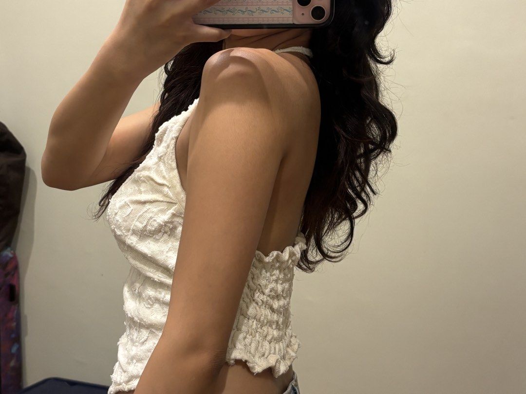 White asymmetric halter top (Category: Sleeveless) located in Paranaque City. Submitted by domisclosett (Listing ID 1466096768, Image 3). Description: - Color: White - Style: Halter top with asymmetric pointed front hem - Material: Super lightweight, textured patterned fabric ideal for warm weather - Fit: Smocked elastic back panel for an easy, comfortable fit and thin adjustable neck straps loc: parañaque/muntinlupa area mop: gcash, maribank, go