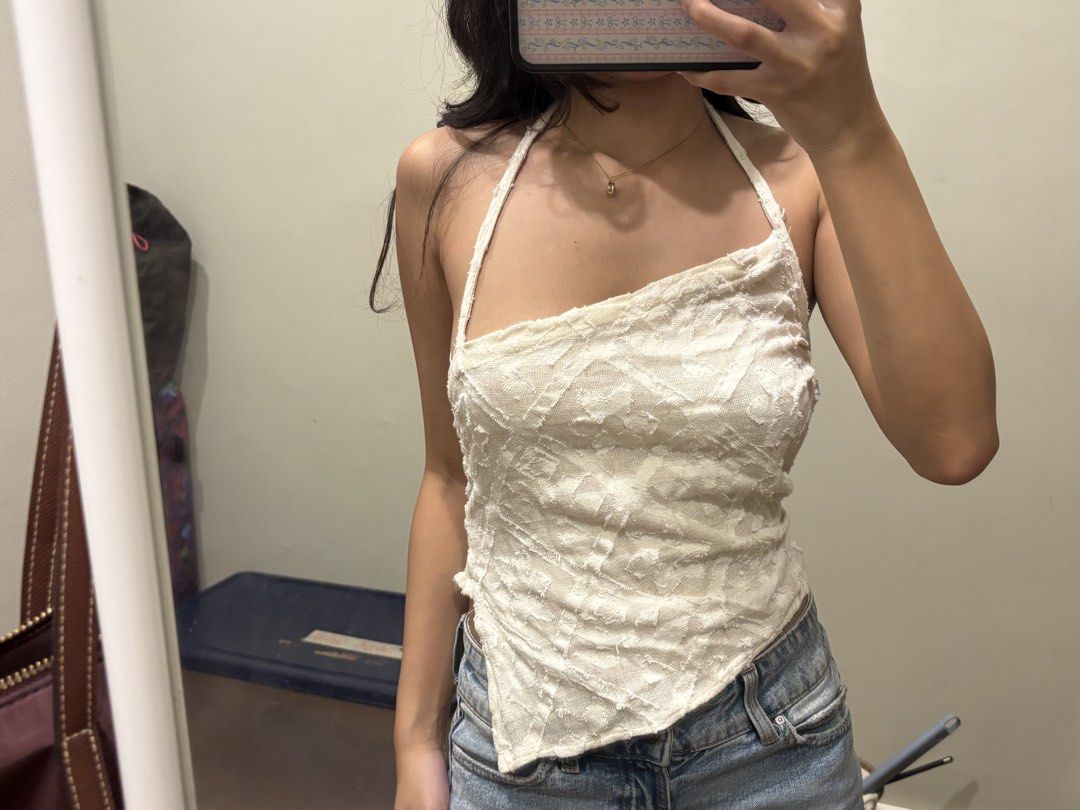 White asymmetric halter top (Category: Sleeveless) located in Paranaque City. Submitted by domisclosett (Listing ID 1466096768, Image 2). Description: - Color: White - Style: Halter top with asymmetric pointed front hem - Material: Super lightweight, textured patterned fabric ideal for warm weather - Fit: Smocked elastic back panel for an easy, comfortable fit and thin adjustable neck straps loc: parañaque/muntinlupa area mop: gcash, maribank, go