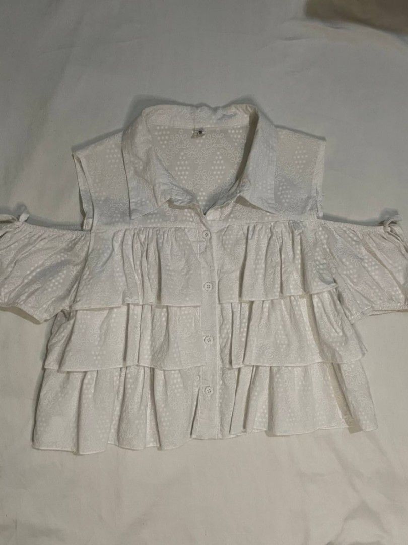 White Cold Shoulder Ruffle Blouse (Category: Blouses) located in Binan City. Submitted by declutterbyjwy (Listing ID 1466092022, Image 1). Description: bust: up to 38-39" | length: 17" - can fit s-m - working buttons - cotton fabric.