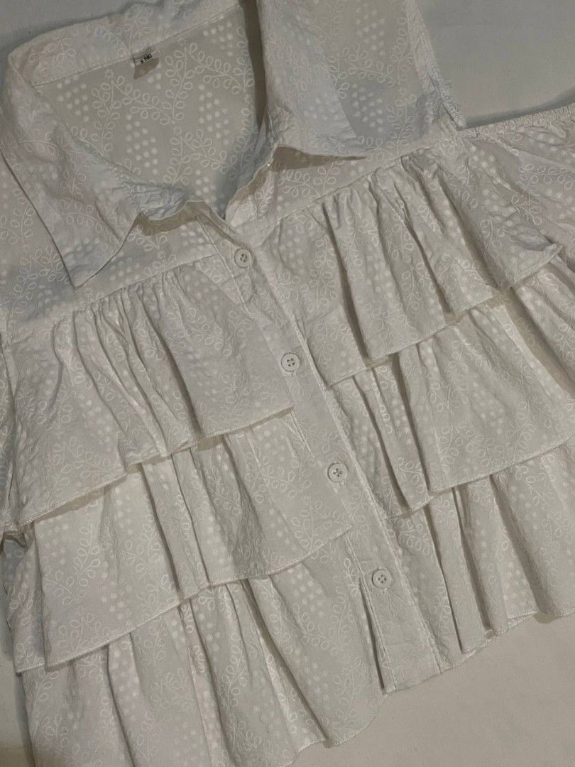 White Cold Shoulder Ruffle Blouse (Category: Blouses) located in Binan City. Submitted by declutterbyjwy (Listing ID 1466092022, Image 2). Description: bust: up to 38-39" | length: 17" - can fit s-m - working buttons - cotton fabric.