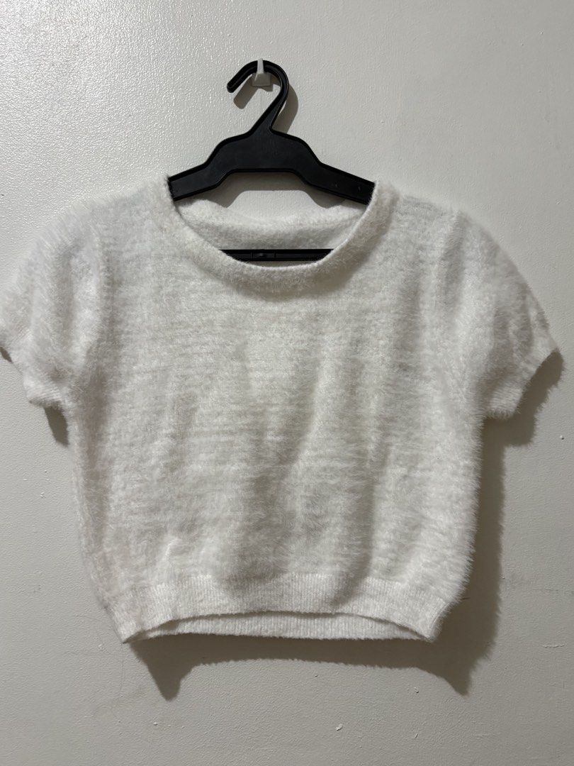 White fluffy knit short sleeve crop top (Category: Shirts) located in Manila. Submitted by nykji96 (Listing ID 1465964811, Image 1). Description: - Color: Solid white - Style: Short sleeve crop top with a boxy cut and scoop neckline - Texture: Soft and fuzzy all over with a ribbed bottom hem - Material: Lightweight and stretchy for a comfortable fit.
