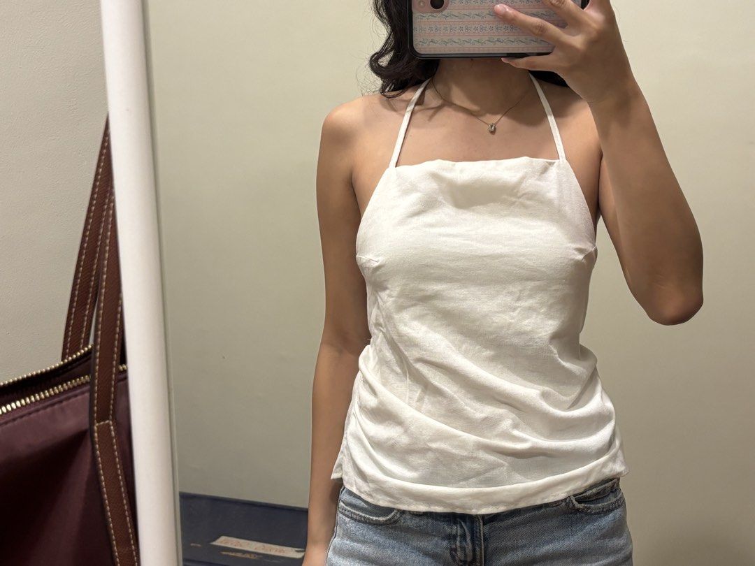 White halter neck open back cami top (Category: Sleeveless) located in Paranaque City. Submitted by domisclosett (Listing ID 1466095528, Image 2). Description: - Style: Halter neck cami with a square neckline and strappy open back detail - Fit: Comfortable with adjustable back straps for a secure fit - note: back straps are kinda twisted! doesnt affect the fit but looks a bit weird loc: parañaque/muntinlupa area mop: gcash, maribank, gotyme mod: 